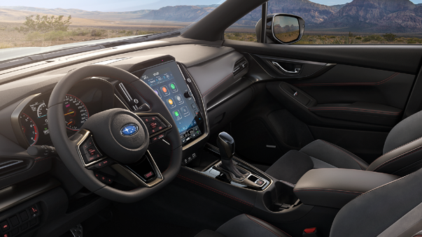 Interior delantero de modelo Subaru, con vista a volante, tablero y pantalla inteligente